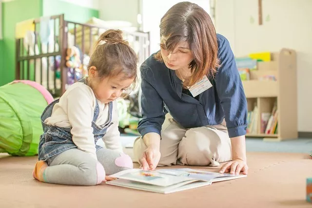 Babysitter reading a book